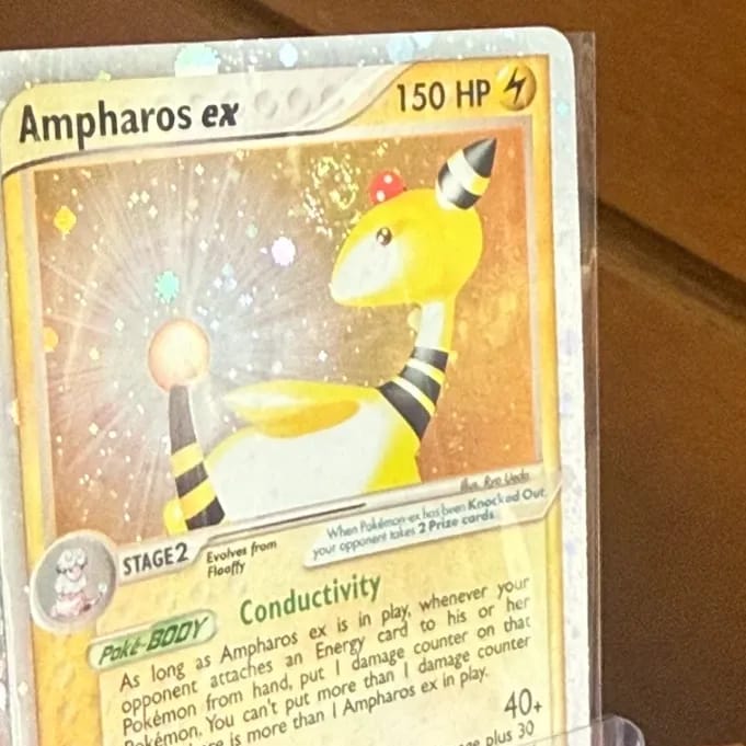 The same Ampharos ex in a sleeve, the holo behind its head smooth.
