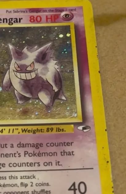 The right edge of Sabrina’s Gengar before cleaning, dark specks along its yellow border.
