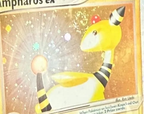 Close-up of Ampharos ex’s holo artwork, the sparkle pattern smooth behind its head.